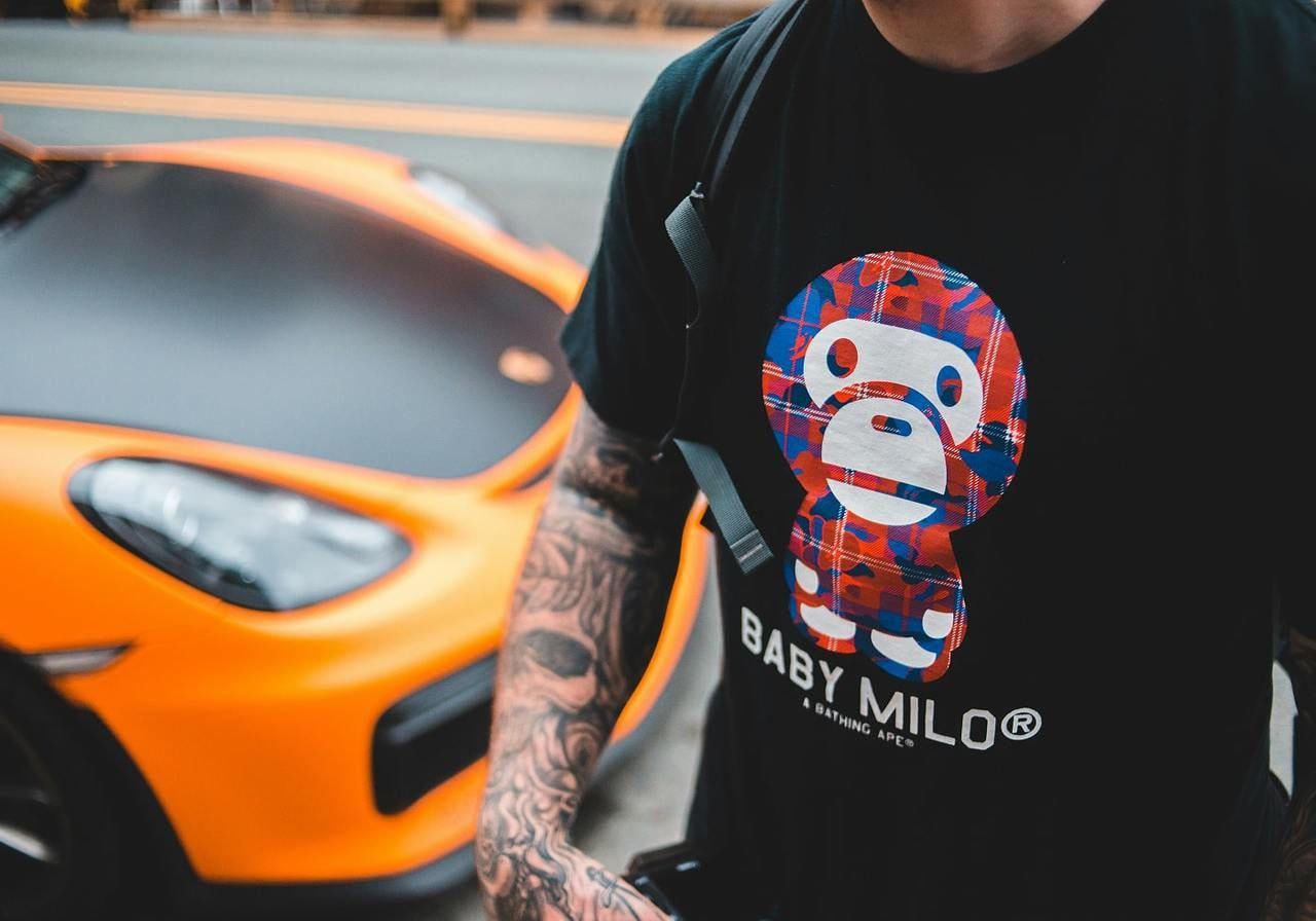 A man is wearing a black t-shirt with an animal-themed print (a monkey) as an example of a best-selling t-shirt design.
