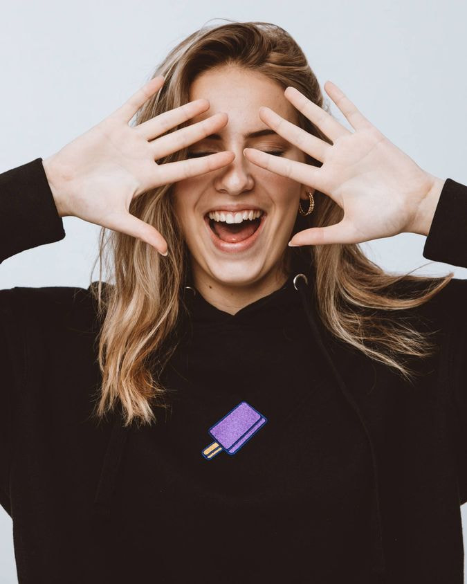 a woman with her hands over her eyes